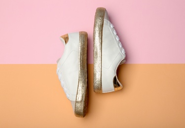 Photo of Stylish new shoes on color background, top view