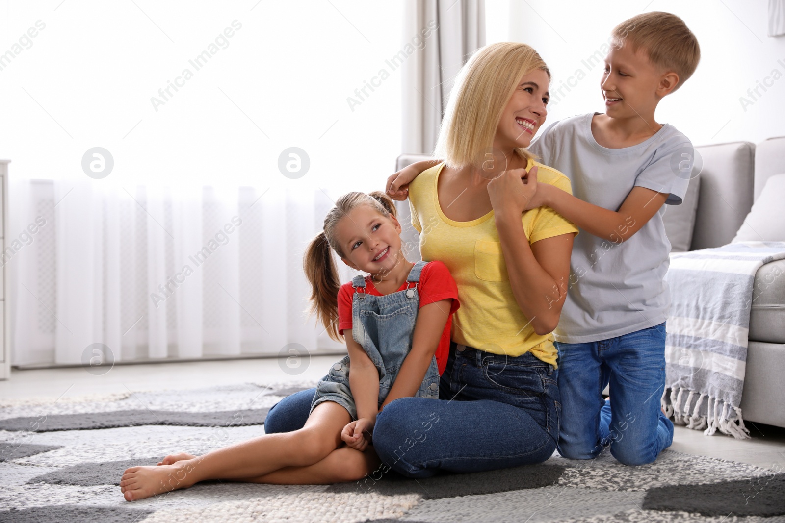 Photo of Happy mother with her children at home