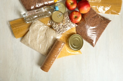 Photo of Many different products on white wooden background, flat lay. Food donation