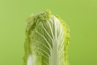 Photo of Fresh ripe Chinese cabbage on light green background, closeup