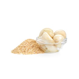 Heap of dehydrated garlic granules and peeled cloves isolated on white