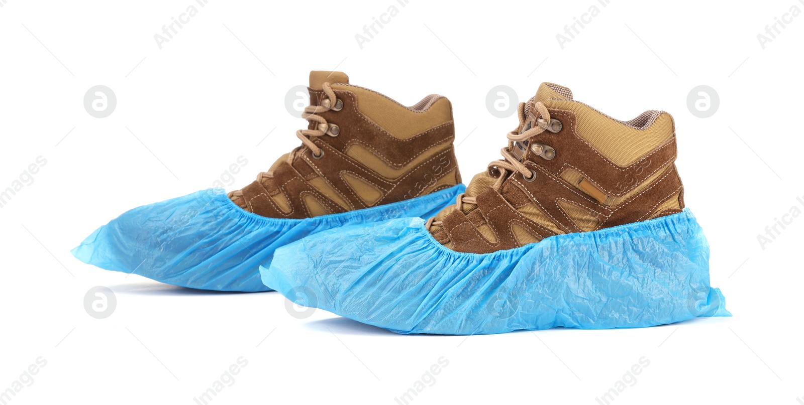 Photo of Boots in blue shoe covers isolated on white