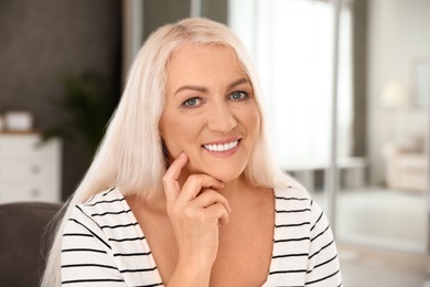 Portrait of mature woman with beautiful face indoors