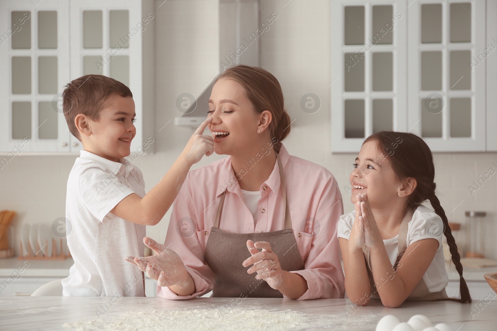 Photo of Happy family cooking together in kitchen at home