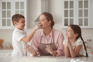 Photo of Happy family cooking together in kitchen at home