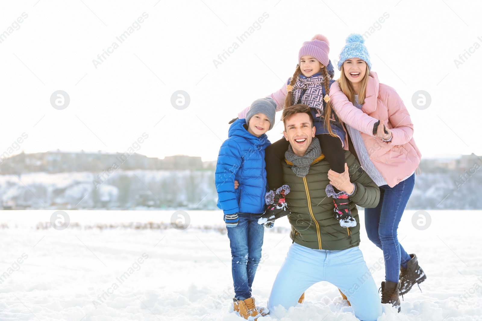 Photo of Portrait of happy family outdoors on winter day