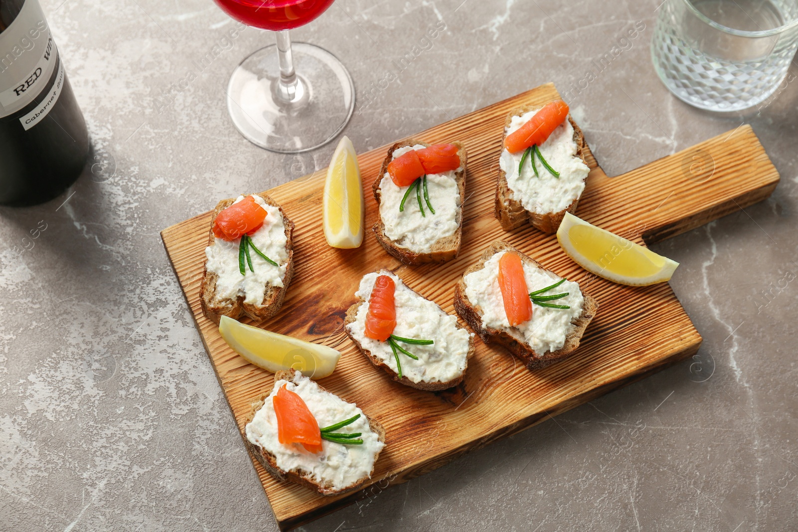 Photo of Sandwiches with fresh sliced salmon fillet on table