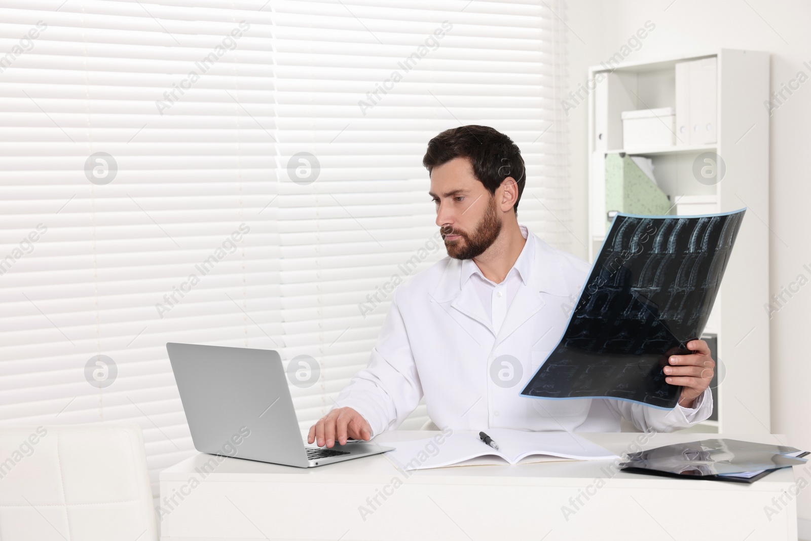 Photo of Doctor examining neck MRI scan in hospital