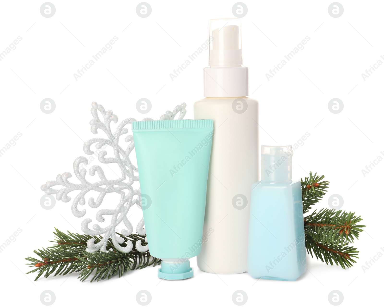 Photo of Set of cosmetic products with hand cream and Christmas decor isolated on white. Winter skin care