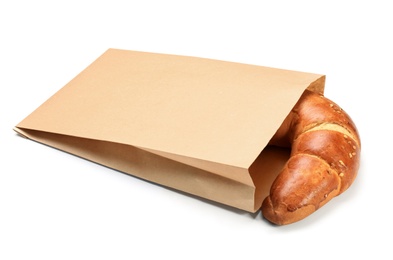 Paper bag with croissant on white background. Space for design