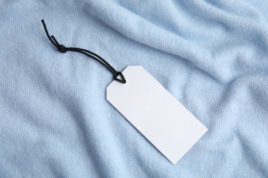 Photo of Warm light blue cashmere sweater with tag, closeup