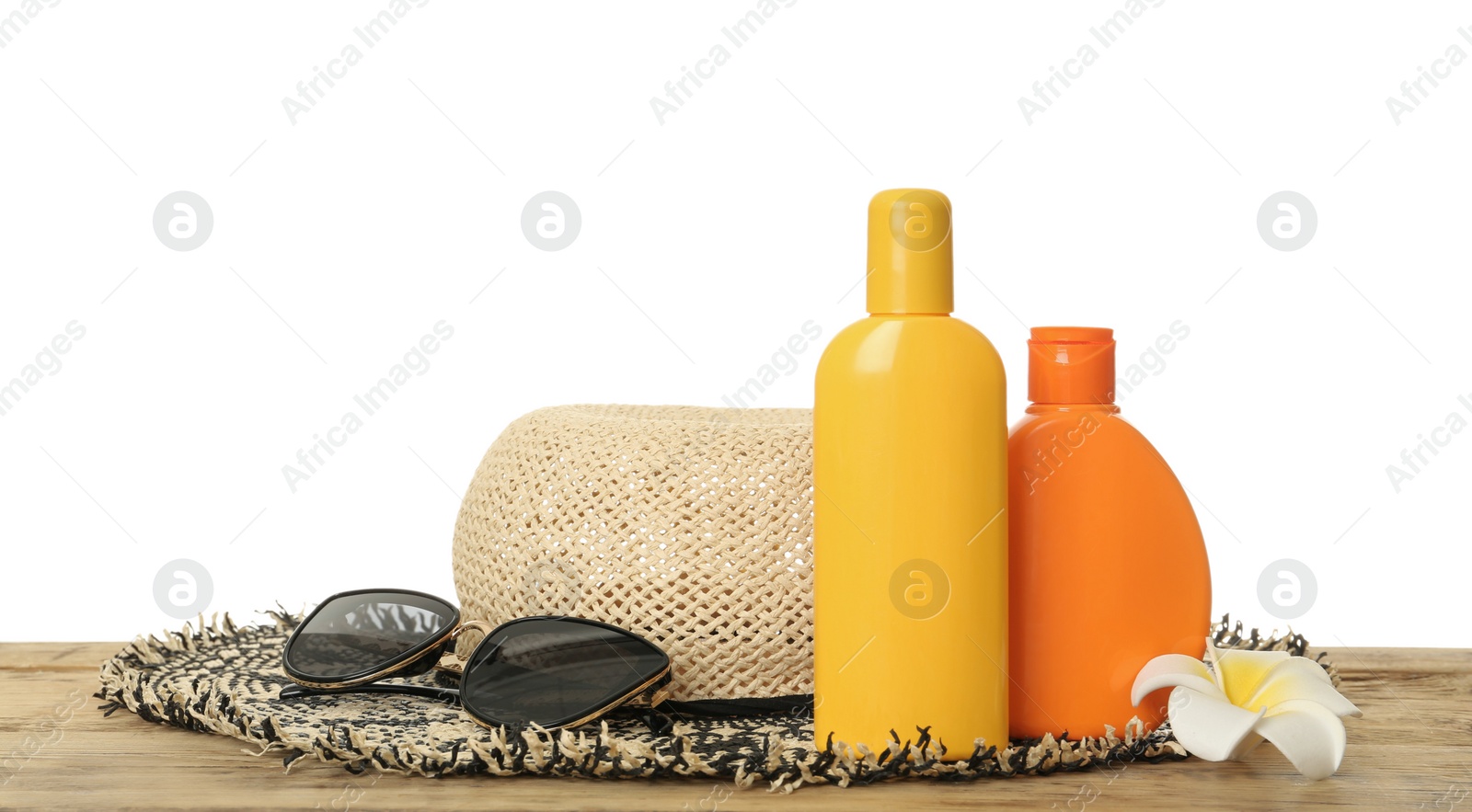 Photo of Sun protection products and beach accessories on wooden table