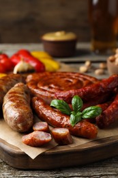 Set of different tasty snacks on wooden table, closeup view