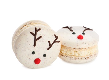 Photo of Delicious Christmas reindeer macarons on white background