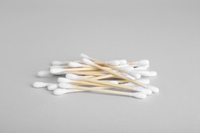 Photo of Wooden cotton buds on light grey background