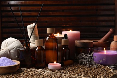 Different aromatherapy products and lavender on table