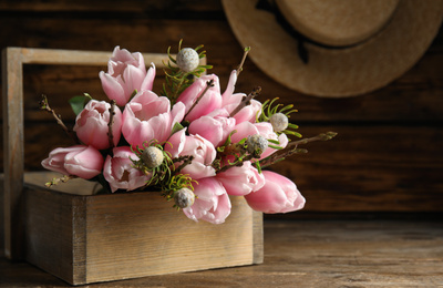 Beautiful bouquet of spring pink tulips on wooden table