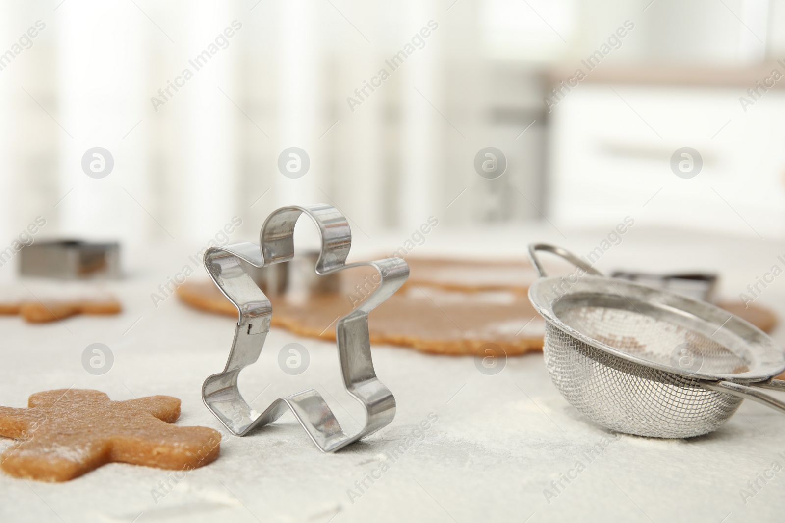 Photo of Making homemade Christmas cookies. Dough and gingerbread man cutter on table, closeup