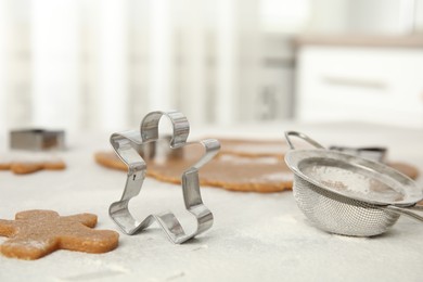 Making homemade Christmas cookies. Dough and gingerbread man cutter on table, closeup