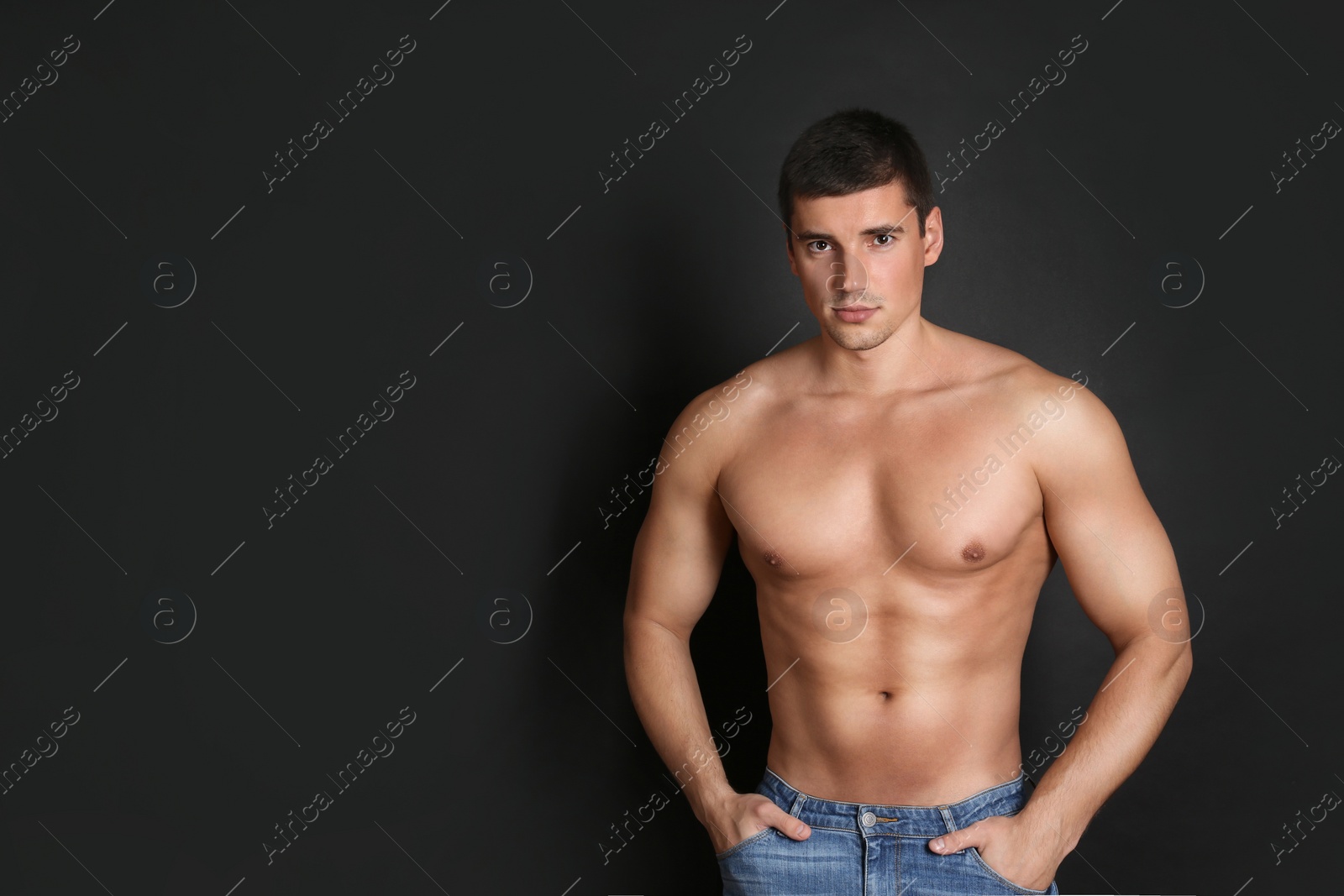 Photo of Man with sexy body on black background. Space for text