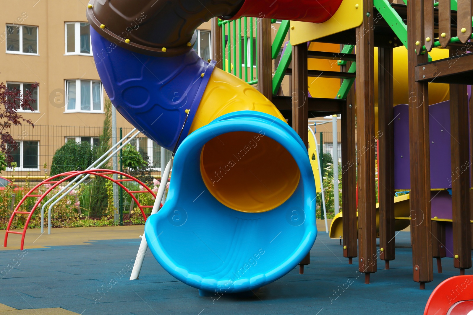 Photo of Colourful slide on outdoor playground for children in residential area