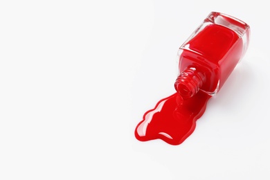 Spilled color nail polish with bottle on white background