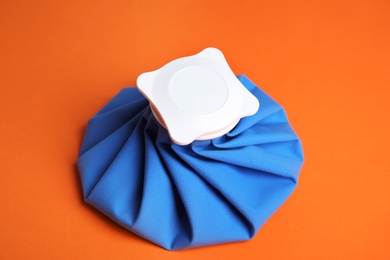 Photo of Ice pack on orange background. Cold compress