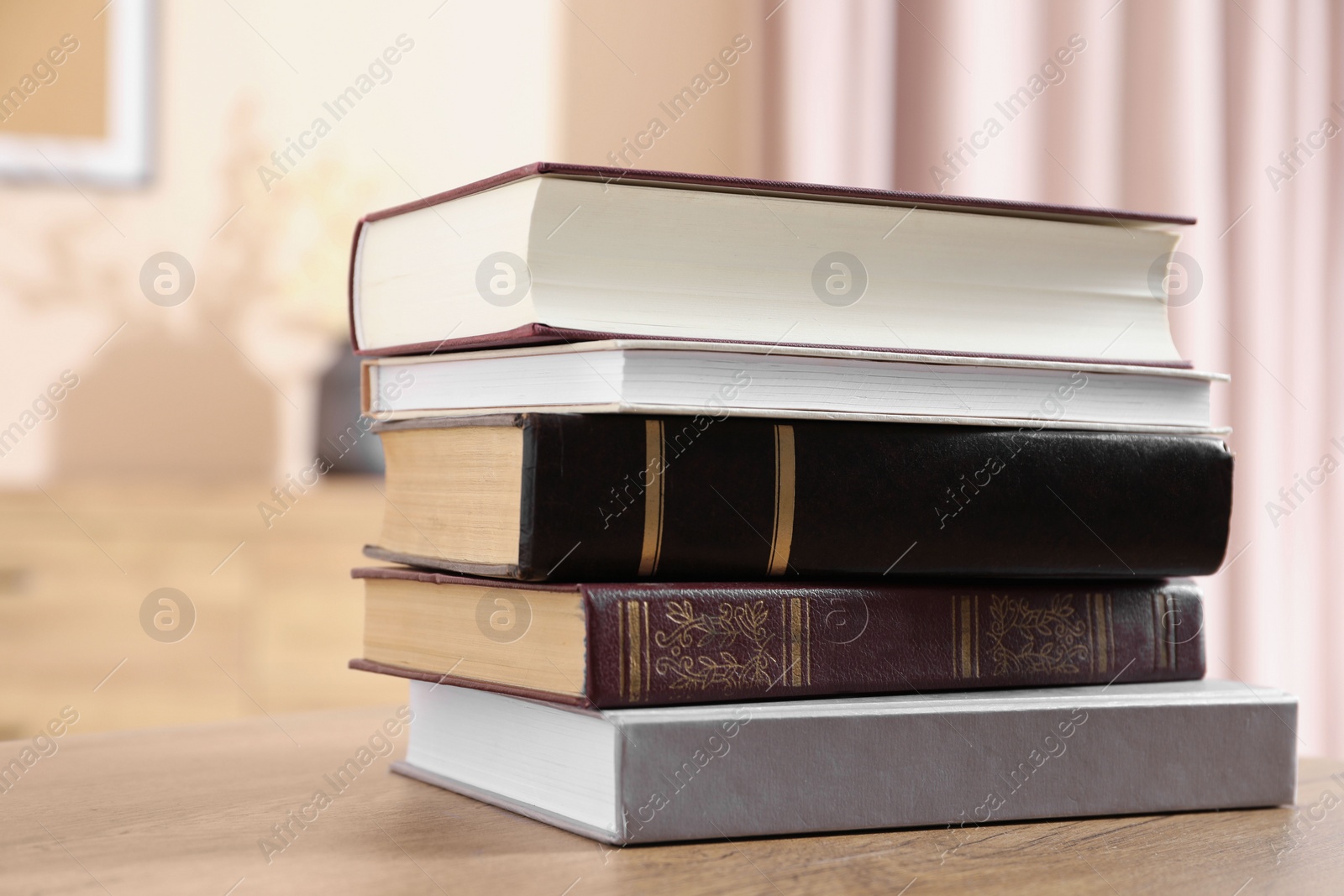 Photo of Books on wooden table in living room