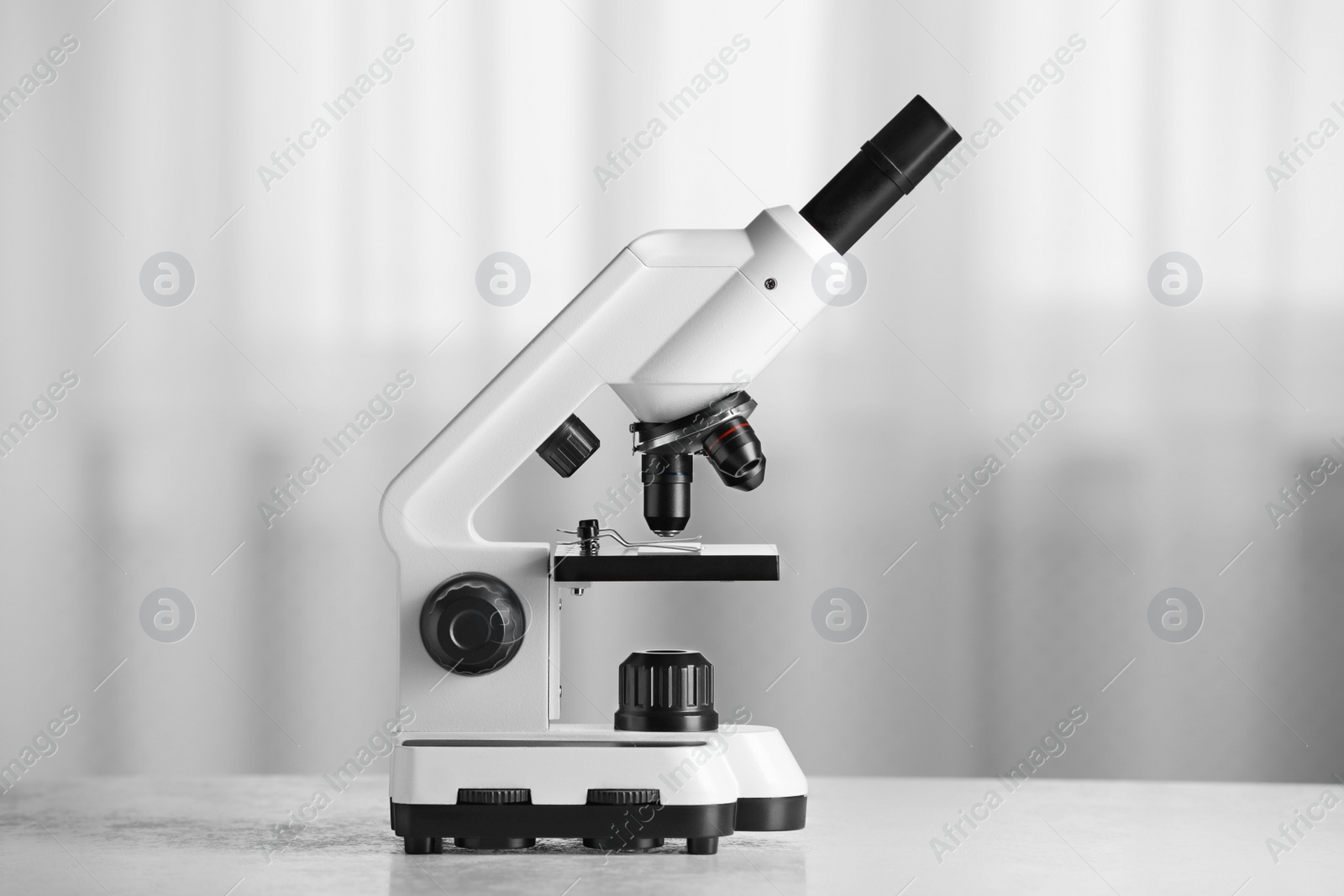 Photo of Modern microscope on table indoors. Medical equipment