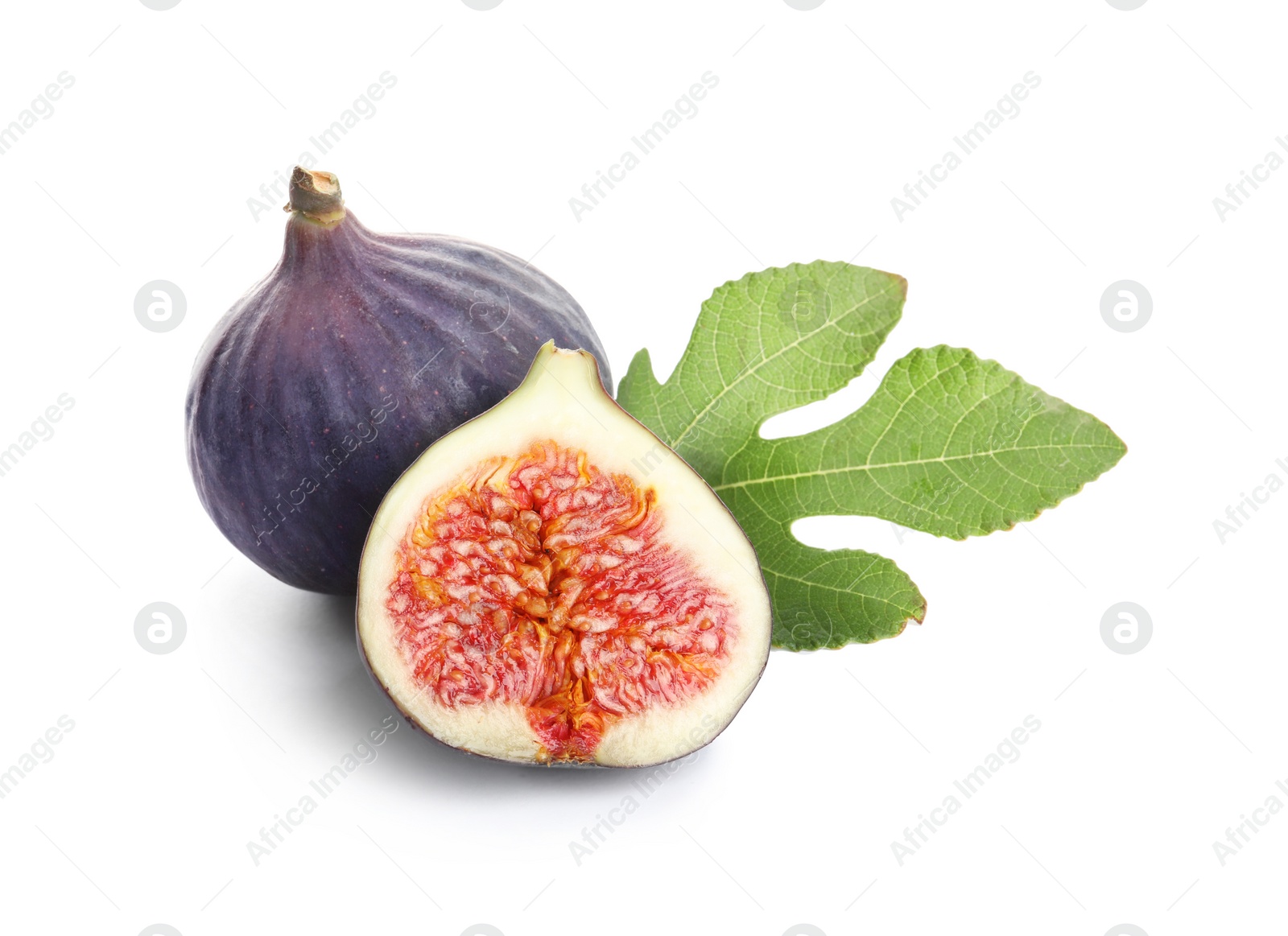 Photo of Whole and cut purple figs on white background