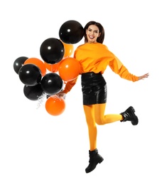 Photo of Beautiful woman with balloons jumping on white background. Halloween party