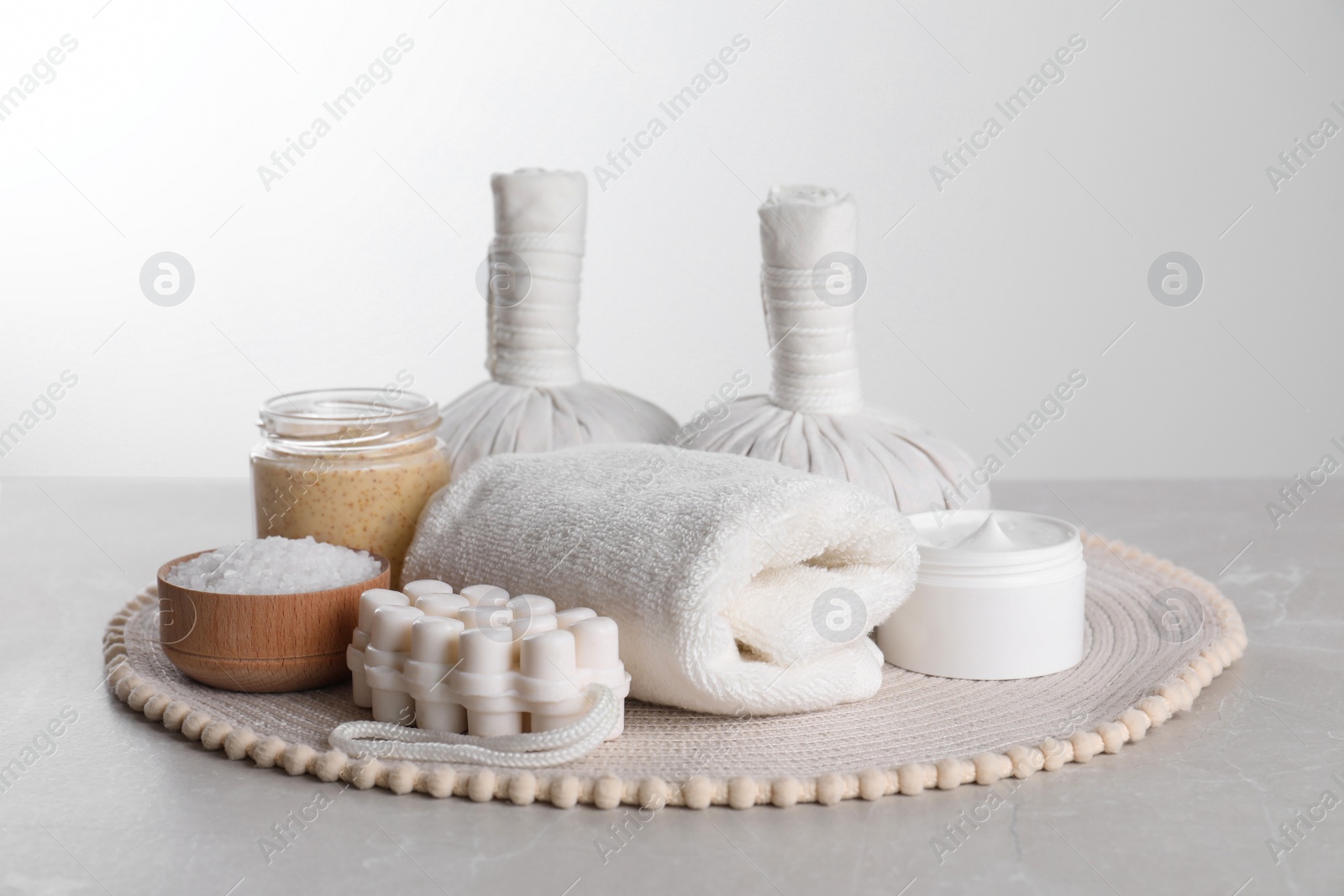 Photo of Spa composition with care products on light grey marble table