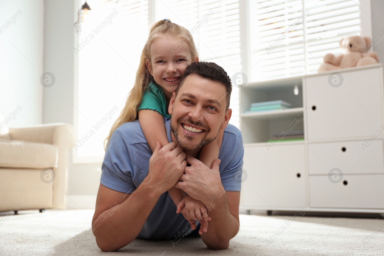 Photo of Dad and daughter spending time together at home. Happy Father's Day