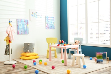 Baby room interior with color furniture and toys