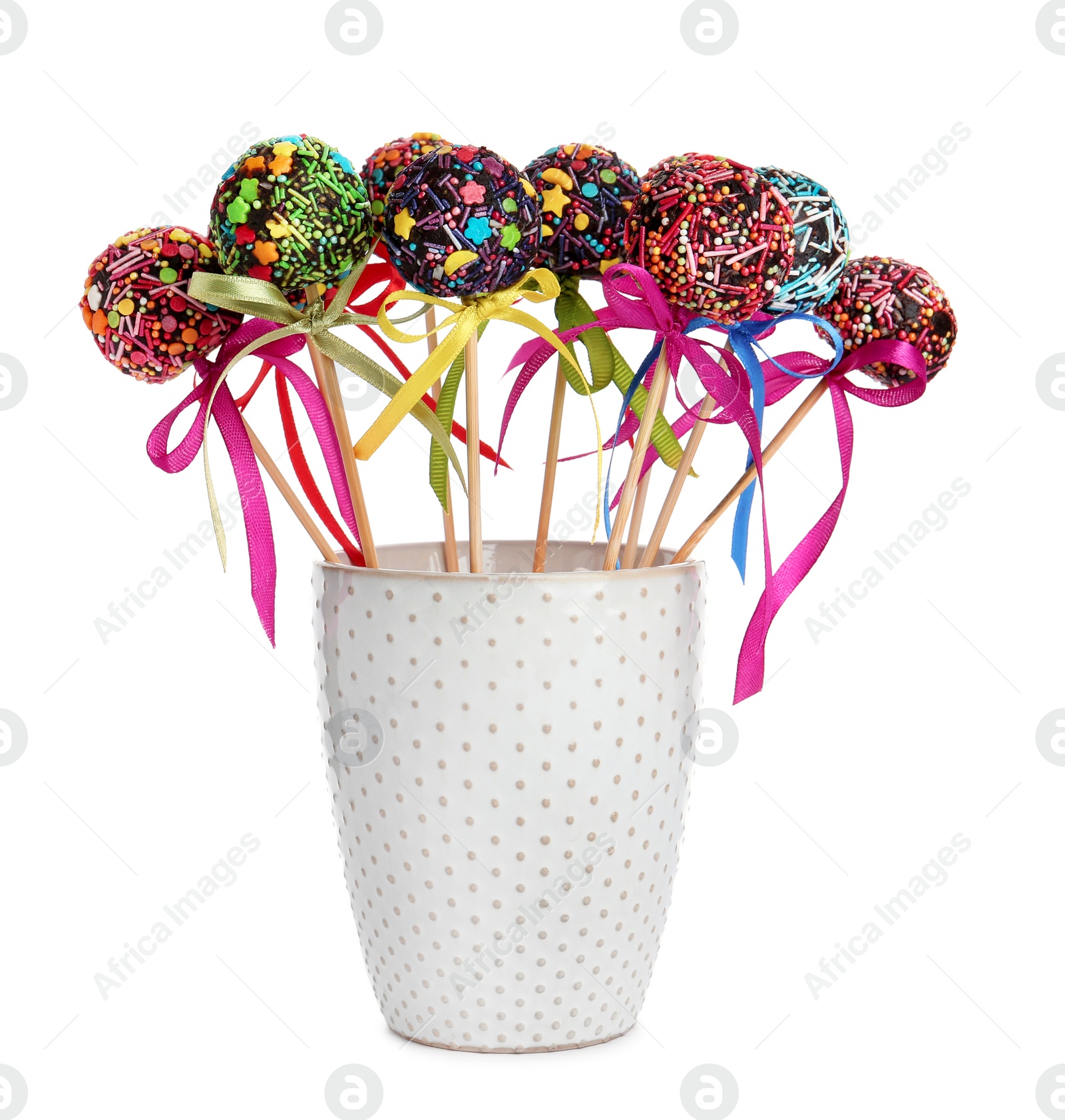 Photo of Sweet cake-pops in glass on white background