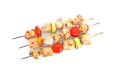 Delicious shish kebabs and grilled vegetables isolated on white, top view