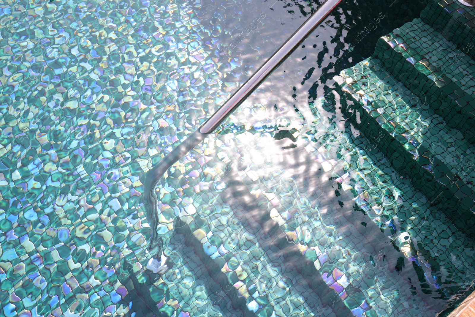 Photo of Outdoor swimming pool with steps and rail at resort