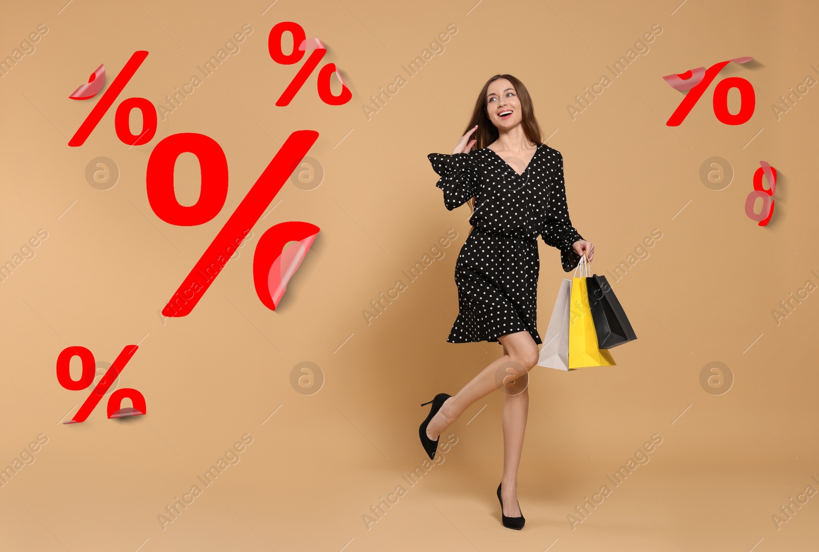 Image of Discount offer. Happy woman with paper shopping bags and percent sign stickers on beige background