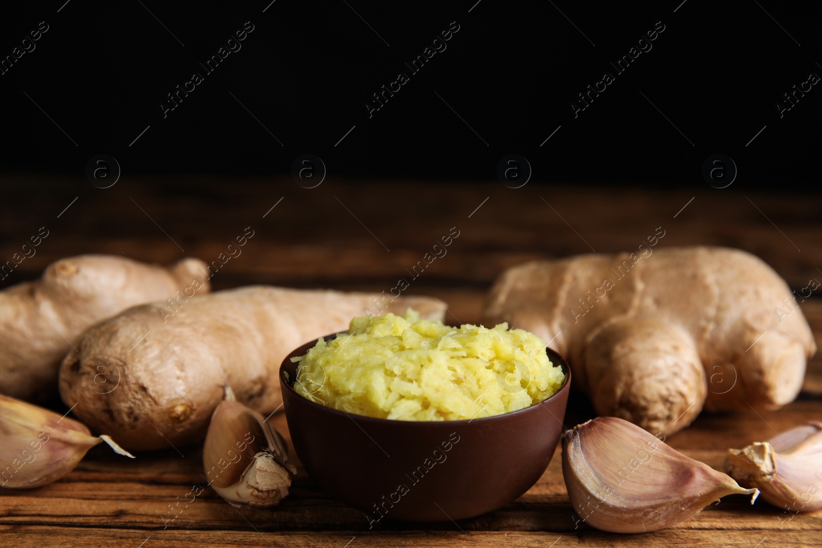 Photo of Fresh garlic and other natural cold remedies on wooden table