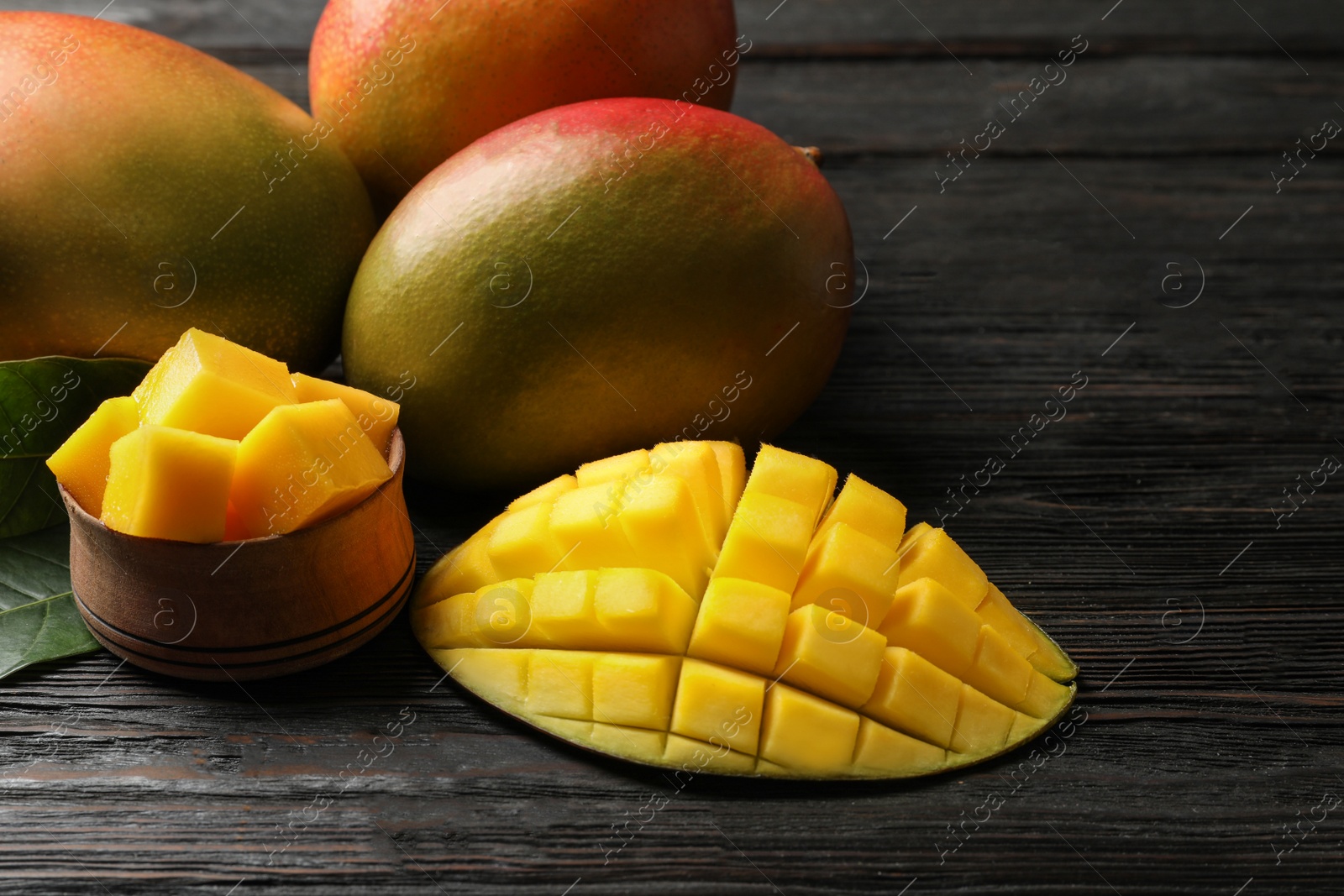 Photo of Composition with fresh mango on wooden background