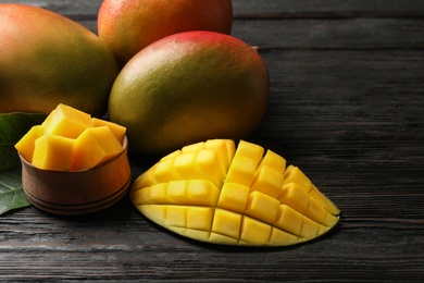 Photo of Composition with fresh mango on wooden background