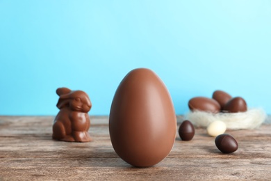 Photo of Beautiful composition with chocolate Easter egg on wooden table