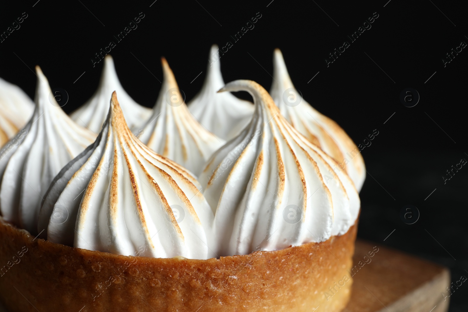 Photo of Tartlet with meringue on table, closeup. Tasty dessert