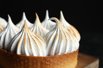 Photo of Tartlet with meringue on table, closeup. Tasty dessert