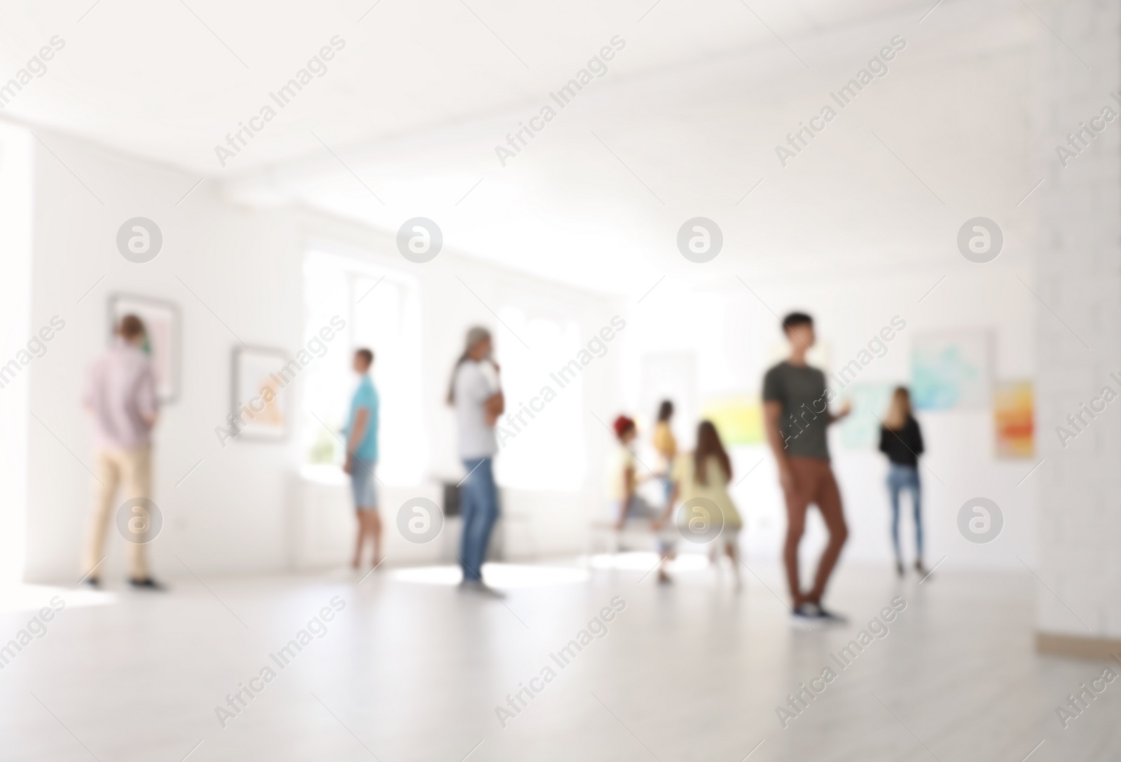 Photo of Blurred view of people at exhibition in art gallery