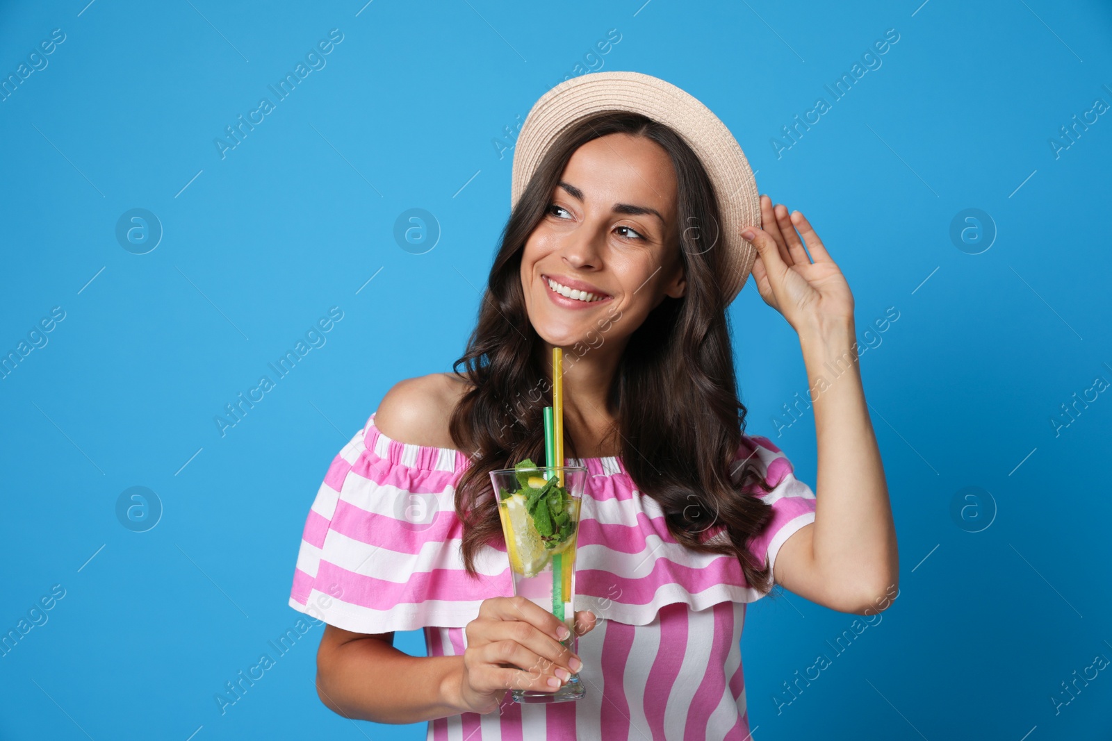 Photo of Young woman with refreshing drink on blue background