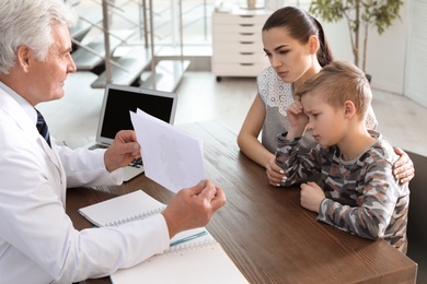 Photo of Little boy passing test at child psychologist office