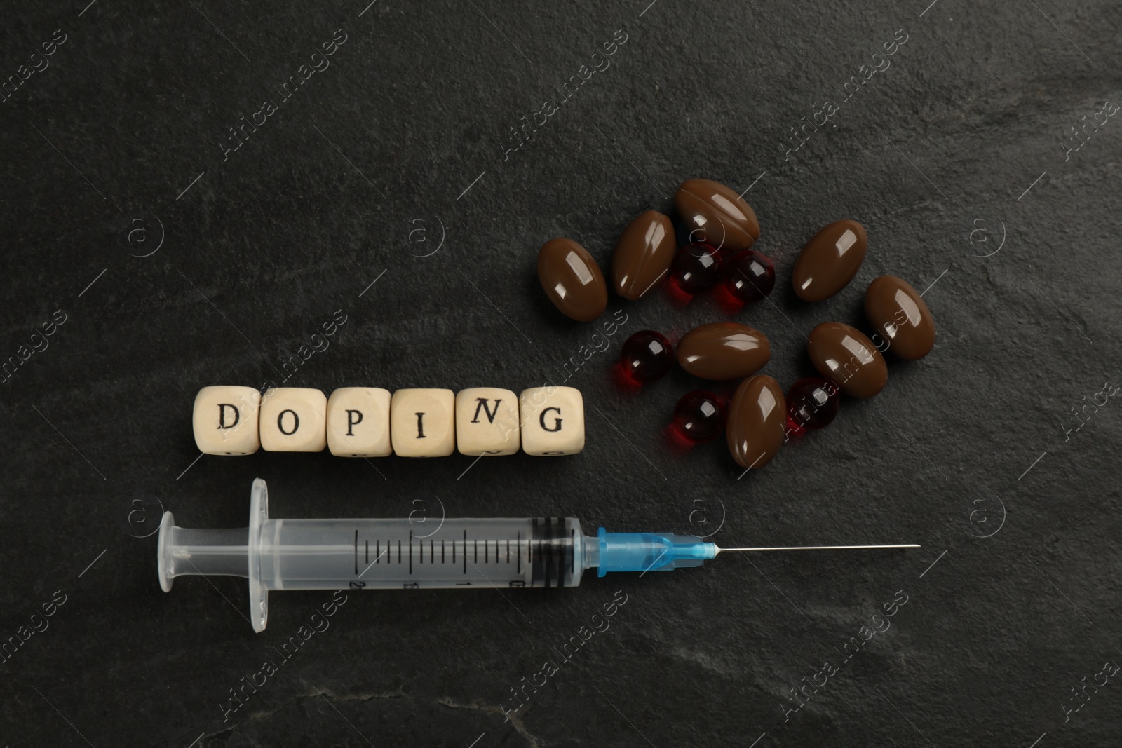 Photo of Wooden cubes with word Doping and drugs on black background, flat lay