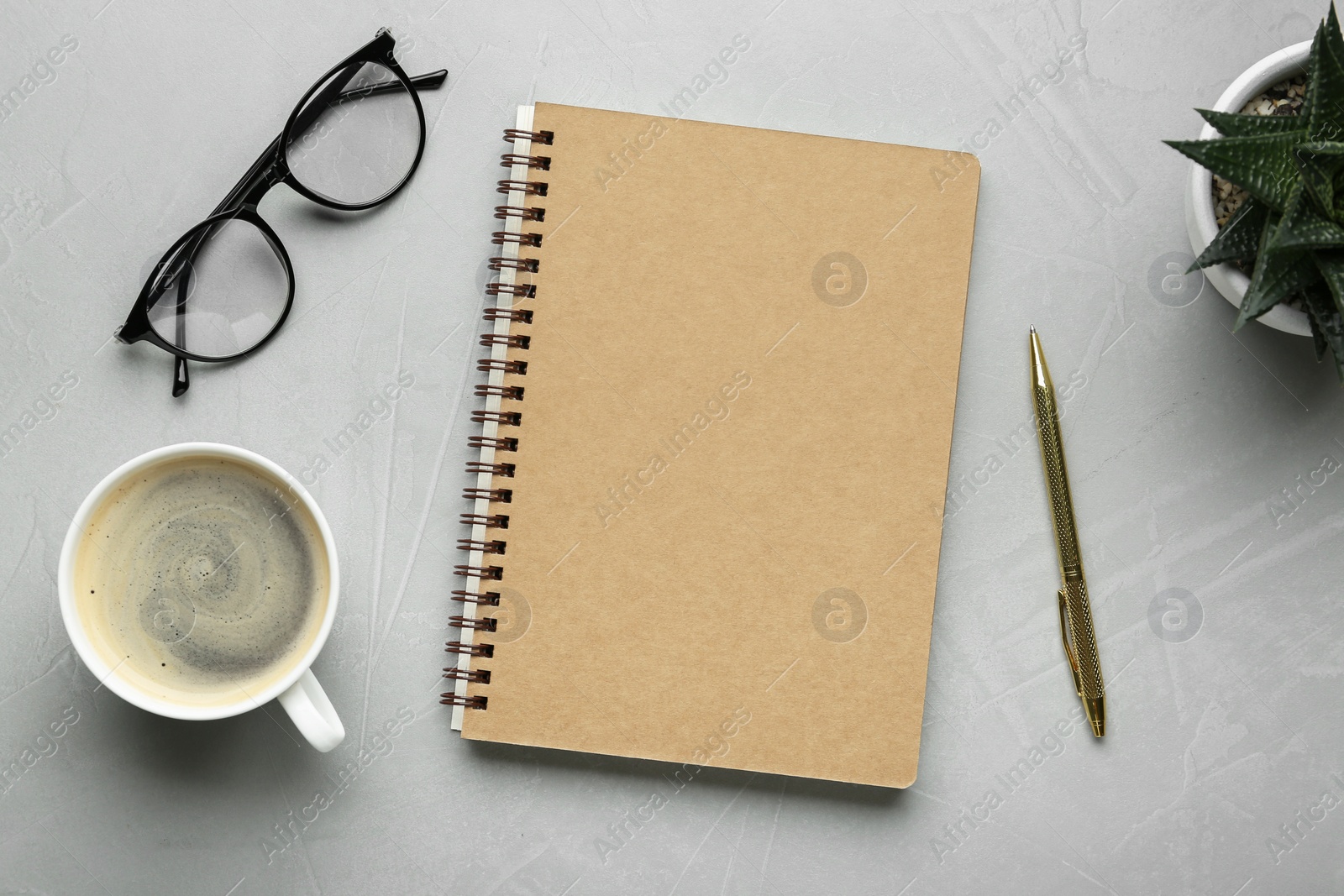 Photo of Flat lay composition with notebook on light textured table