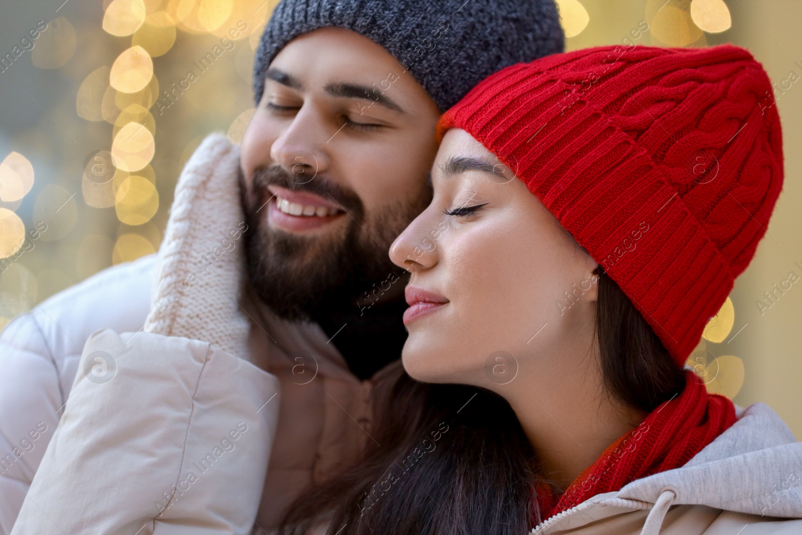 Photo of Portrait of lovely couple outdoors against blurred lights outdoors